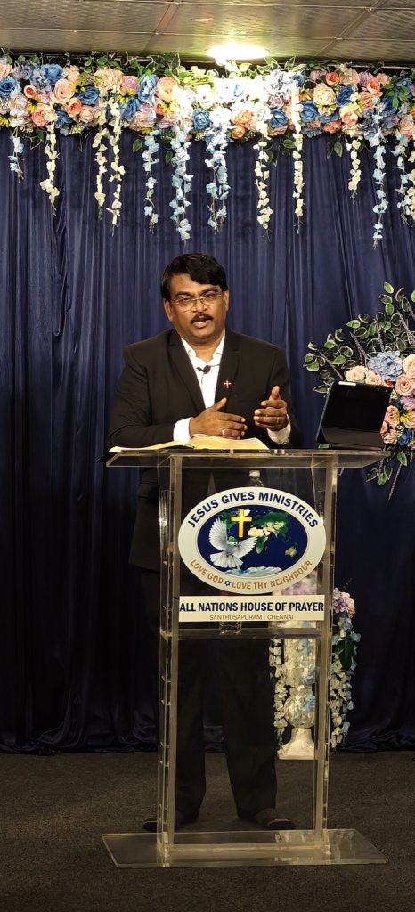 Rev. Dr. P. Arul Selvaraj preaching at the Jesus Gives Ministries pulpit
