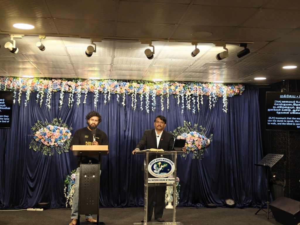 Sunday worship stage at All Nations House of Prayer, Santhosapuram, Chennai, with Rev. Dr. P. Arul Selvaraj and translator