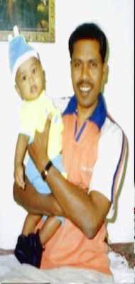 Bro. Amanlakra holding his baby son, a testimony of answered prayer