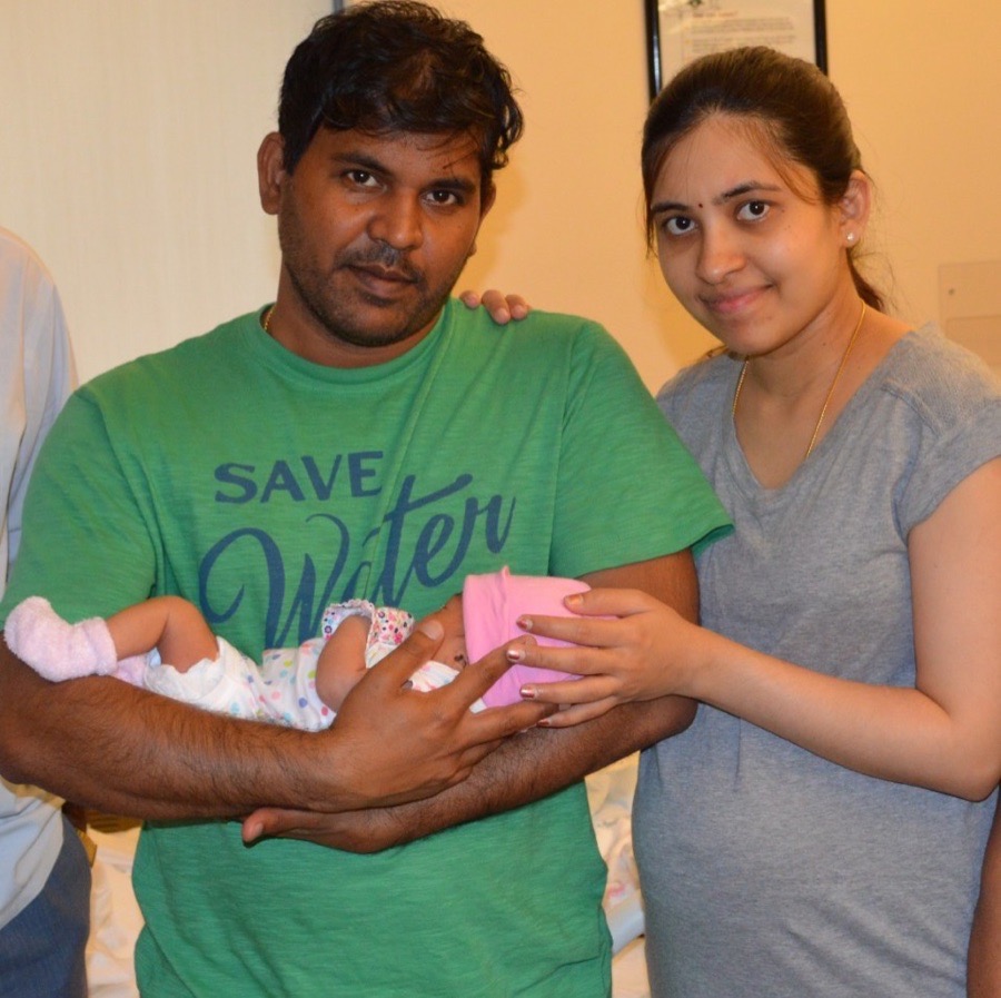 Bro. Pratap and his wife holding their newborn daughter, a testimony of answered prayer