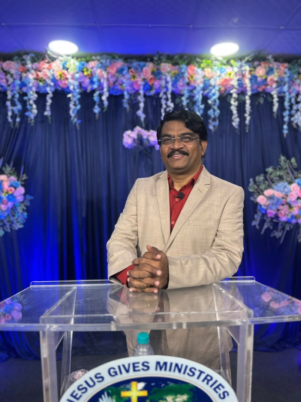 Rev. Dr. P. Arul Selvaraj at the Jesus Gives Ministries pulpit